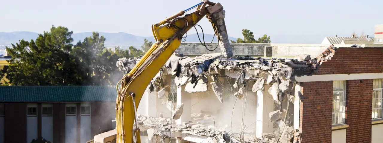 Excavator demolishing a building