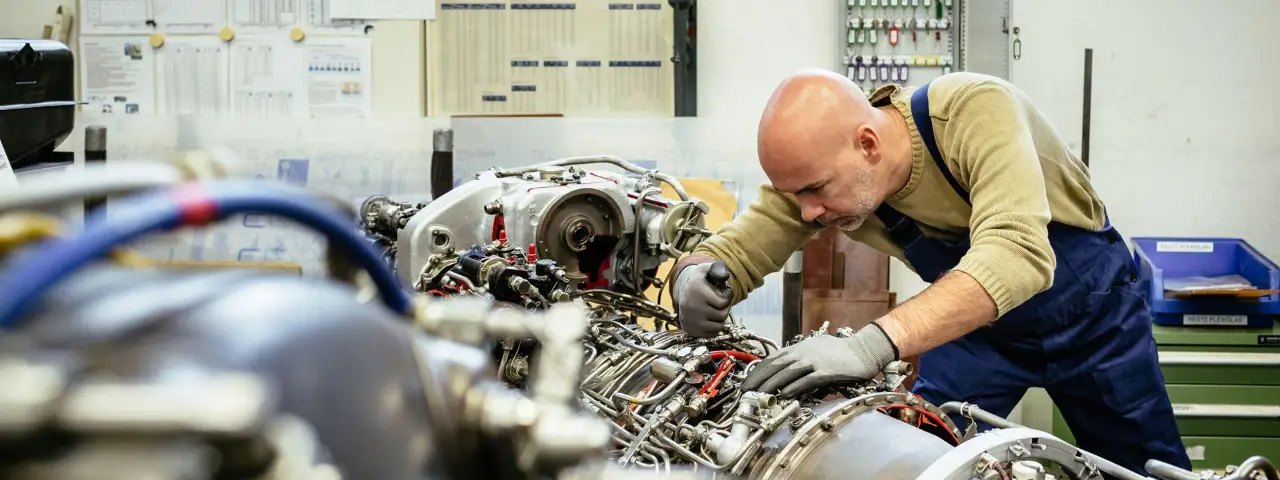 A worker performing maintenance on a machine