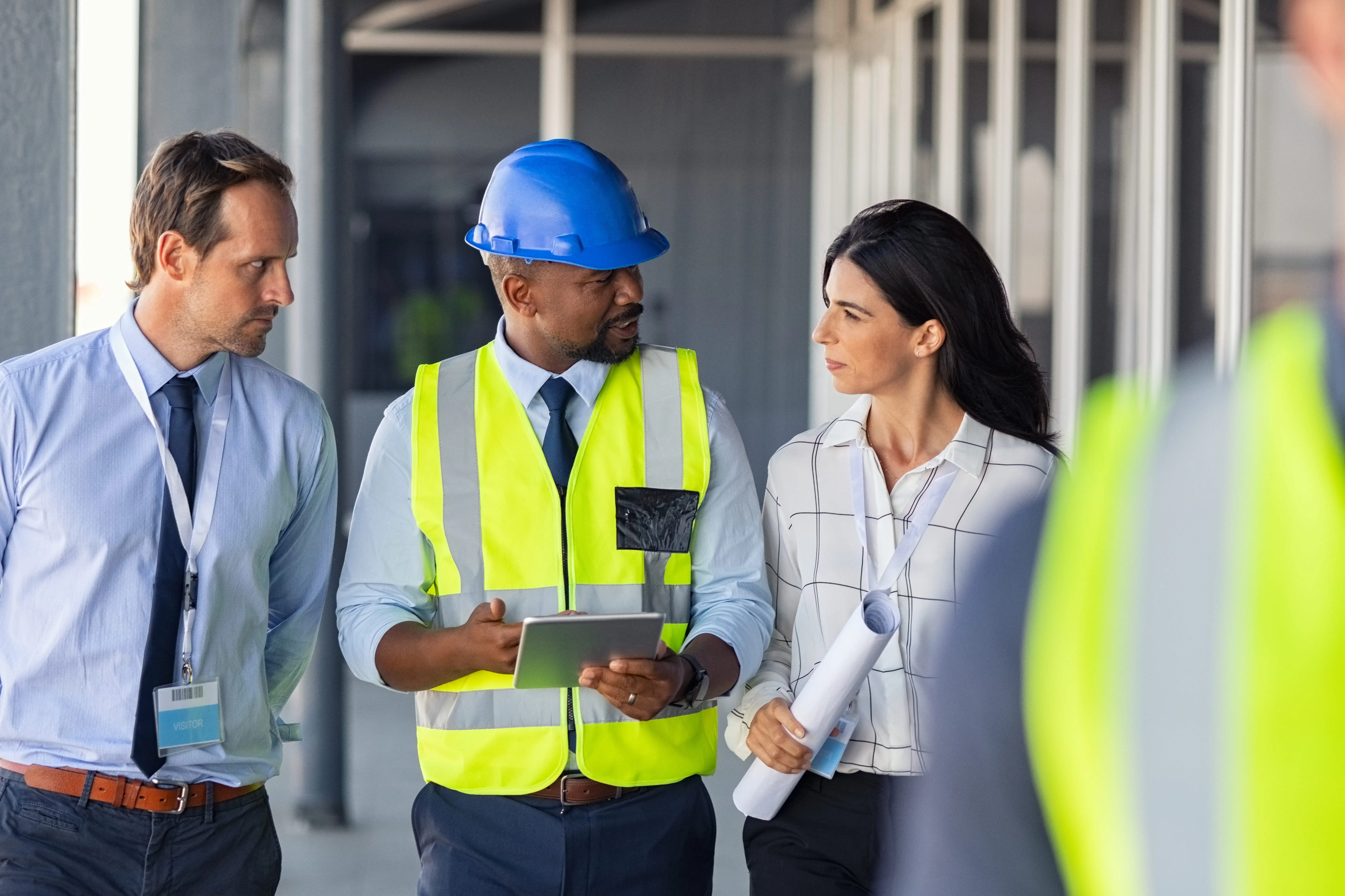 A safety worker holds a permit approval document