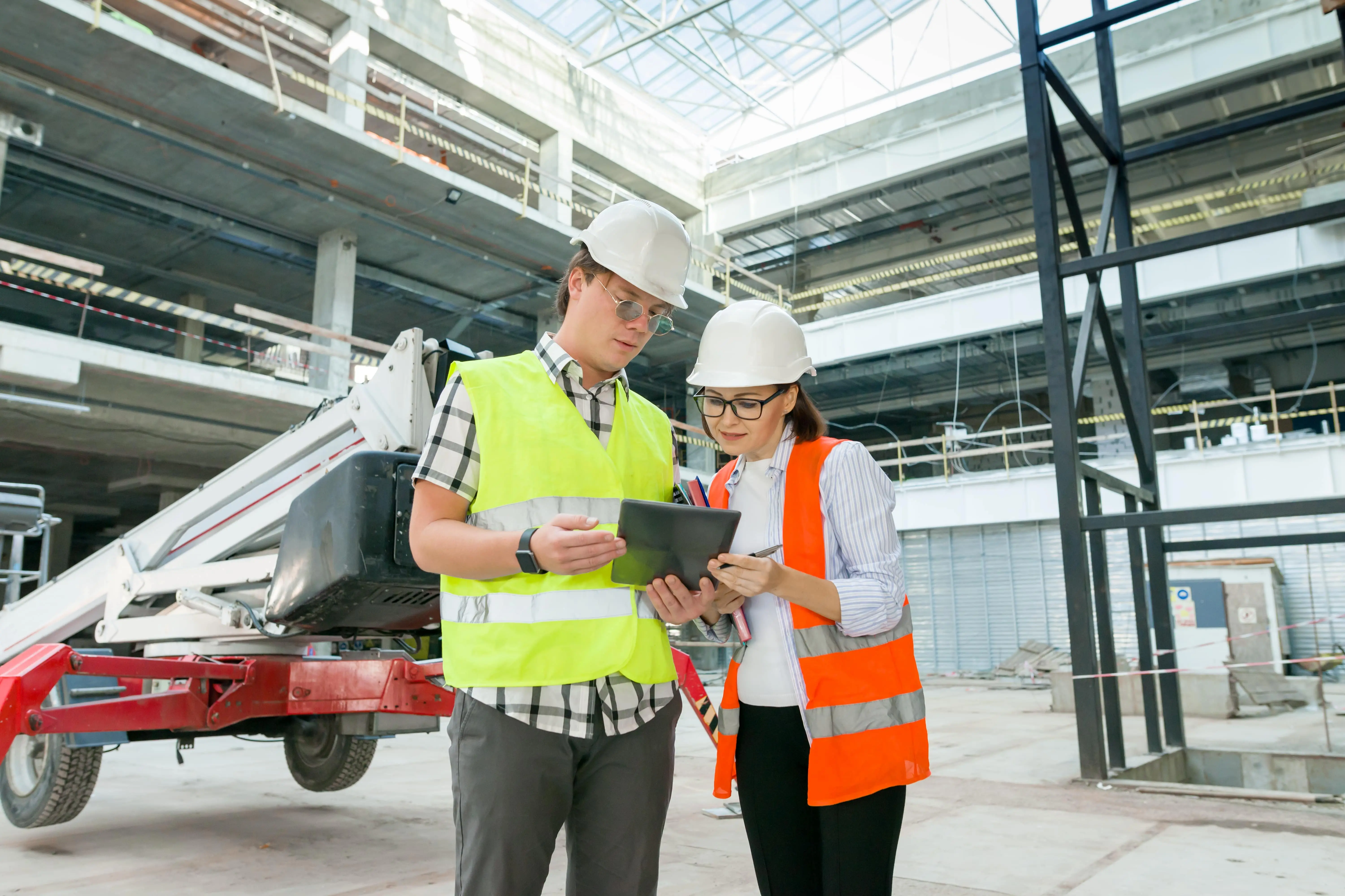 Three safety workers engaged in a discussion while reviewing an inspection checklist